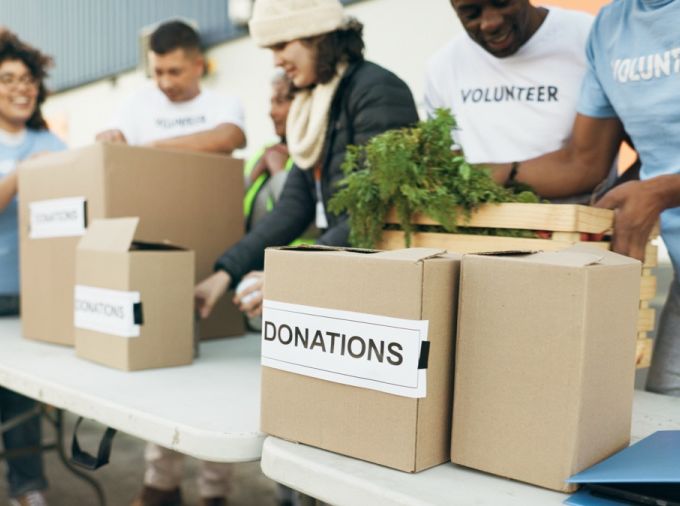School kids engaging with their local community by volunteering to help with donations.