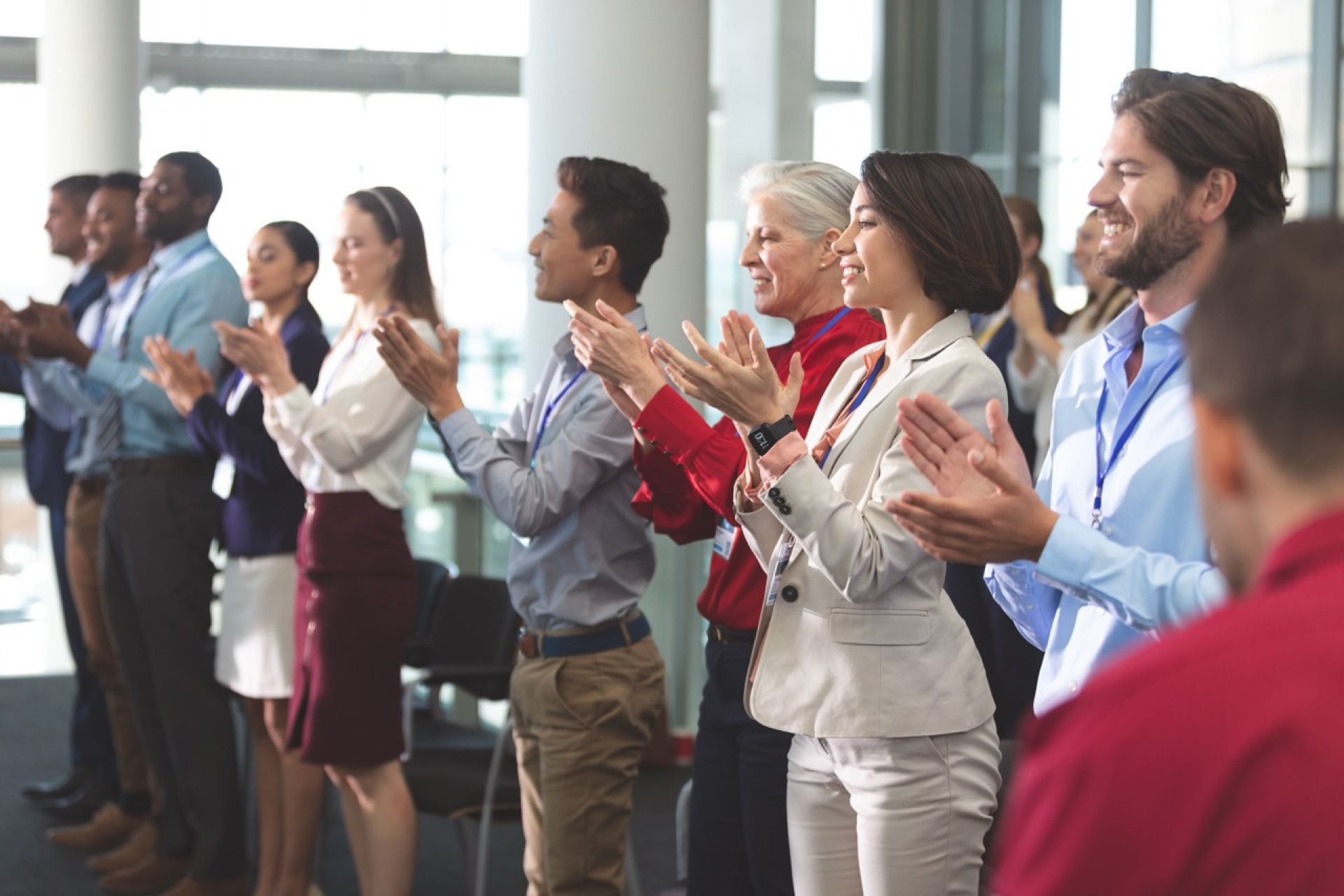 Crowd of professionals clapping for award winners.